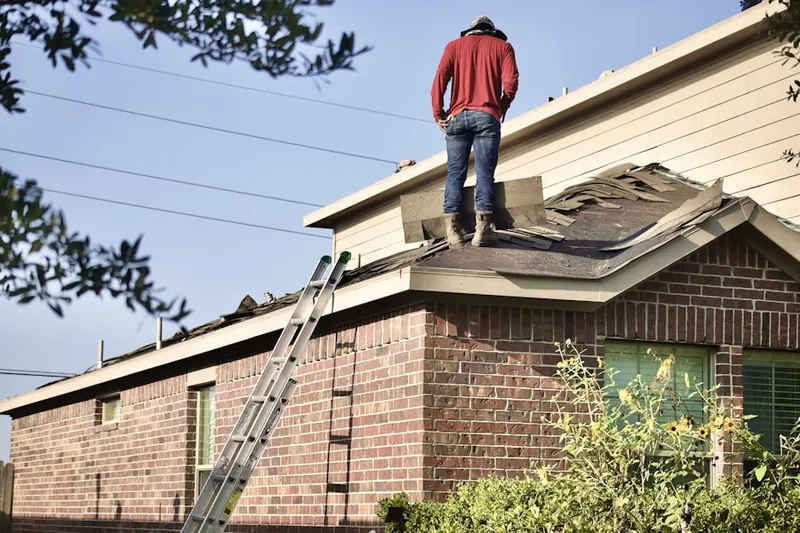 Professional roofer working on a residential roof in Bachman